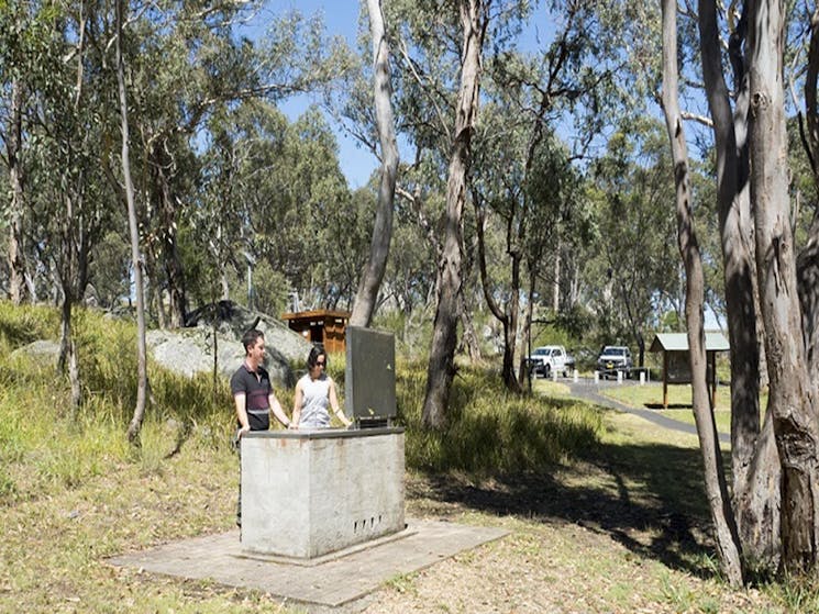Two people at the barbecue, Threlfall picnic area, Oxley Wild Rivers National Park. Photo: Leah