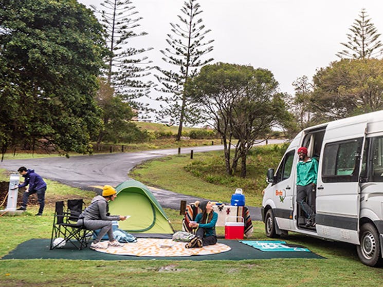 Campers picnicking next to their campervan at Trial Bay Gaol campground, Arakoon National Park.