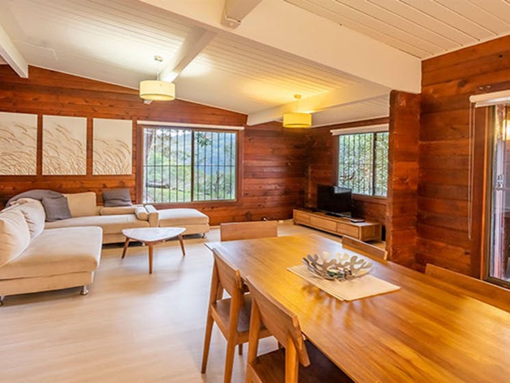 Open plan lounge and dining room at Weemalah Cottage, Royal National Park. Photo: John Spencer/OEH