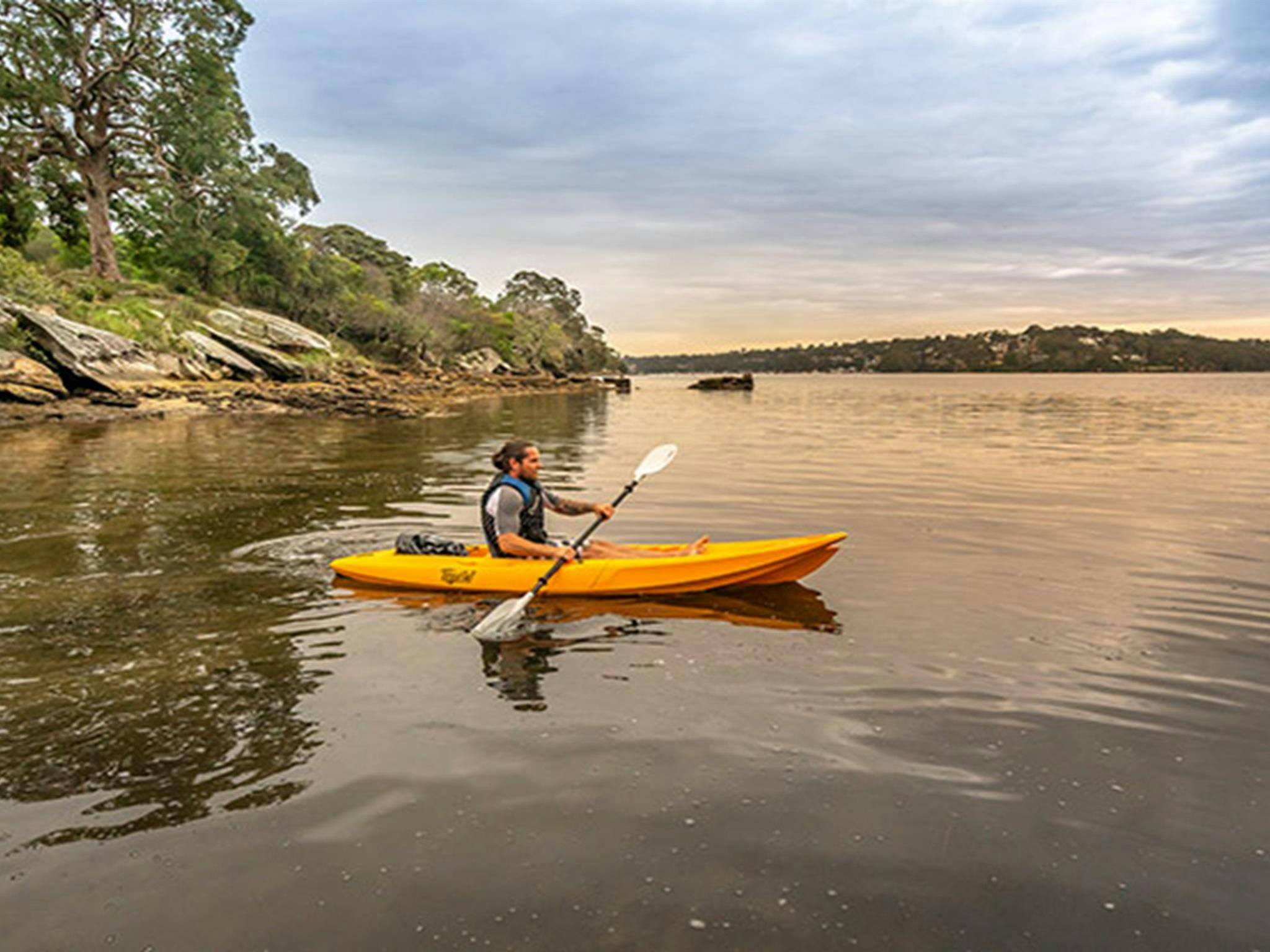一名男子在皇家國家公園威瑪拉小屋附近的哈金港劃皮艇。照片：約翰·史賓塞/OEH