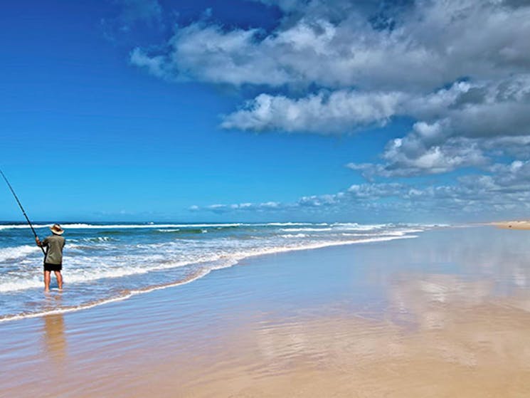 A man fishing on the beach in Worimi National Park. Photo: John Spencer &copy; DPIE