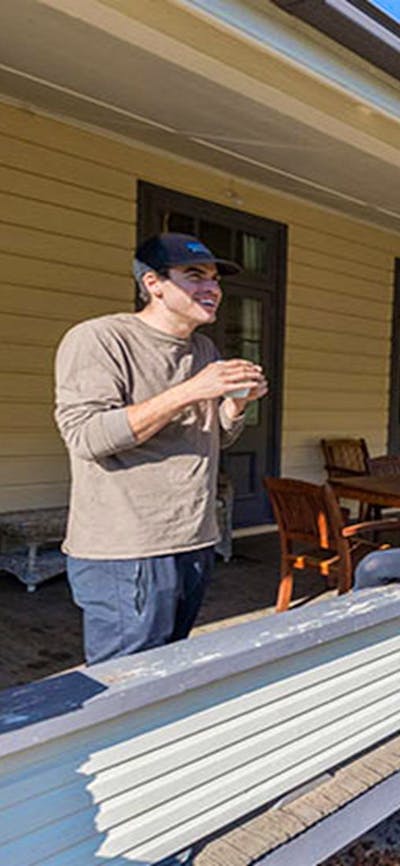 A couple on the verandah at Yarrangobilly Caves House 1901 section, Kosciuszko National Park. Photo: