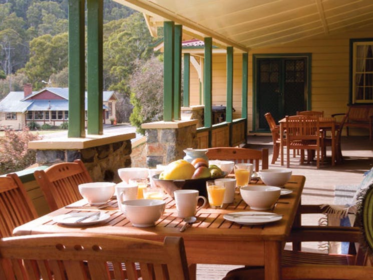 Breakfast on the verandah at Yarrangobilly Caves House 1901 section, Kosciuszko National Park.