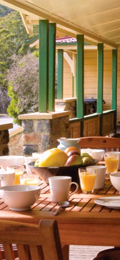 Breakfast on the verandah at Yarrangobilly Caves House 1901 section, Kosciuszko National Park.